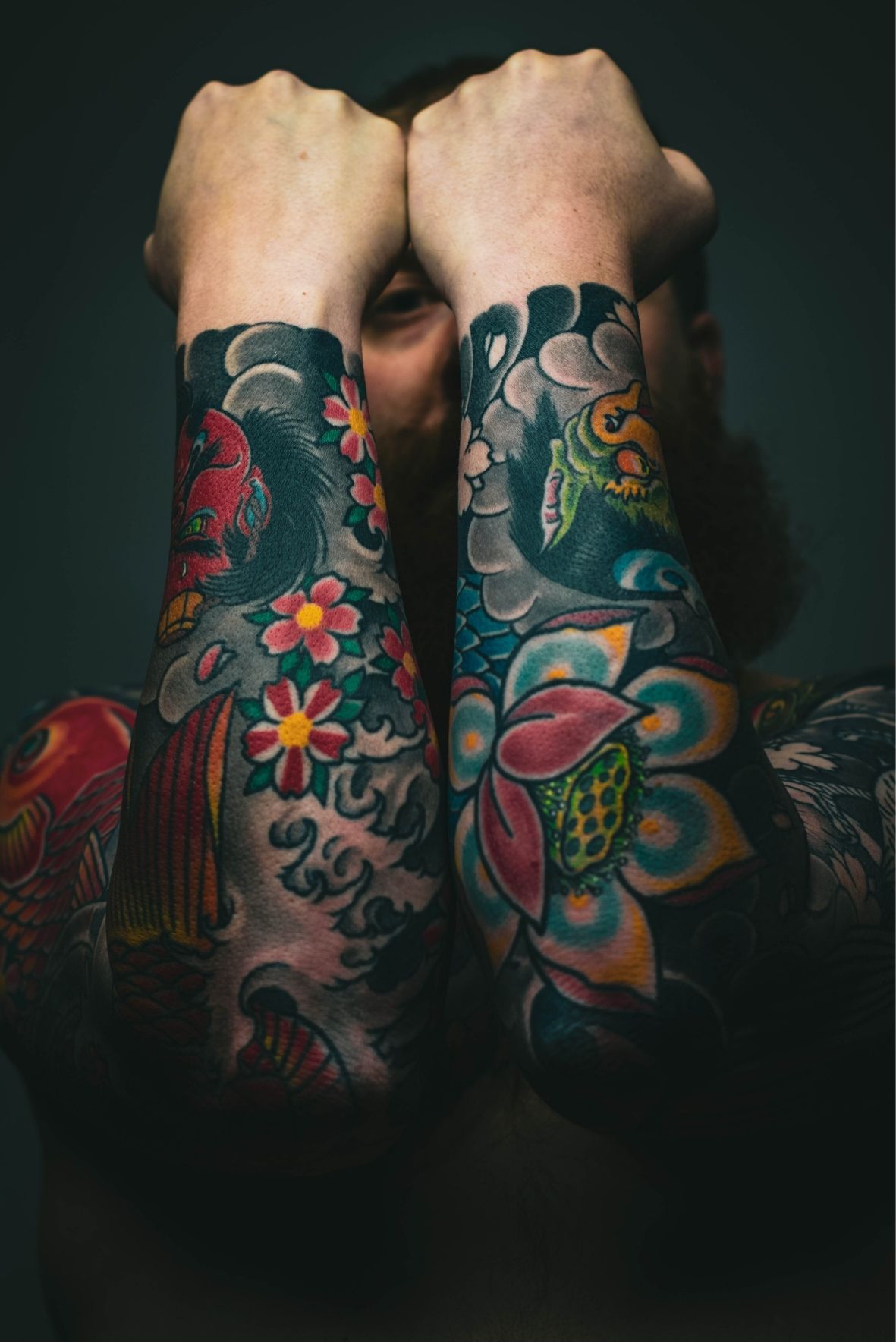 Avant-bras entièrement couverts de tatouages colorés avec motifs floraux et illustratifs  dans Lotbinière